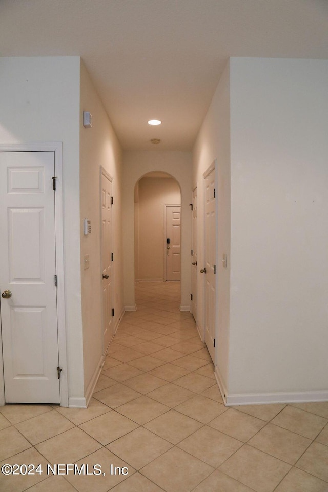 corridor featuring light tile patterned flooring