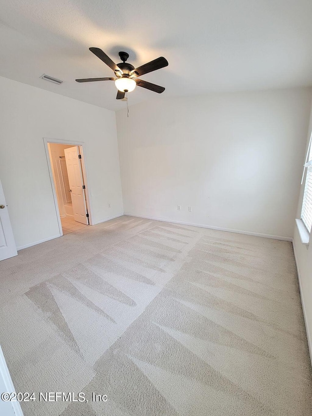 carpeted empty room featuring ceiling fan