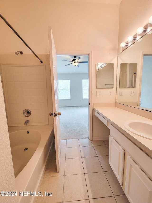 bathroom with ceiling fan,  shower combination, tile patterned flooring, and vanity