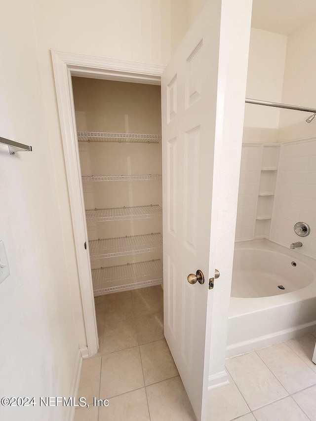 bathroom featuring bathtub / shower combination and tile patterned flooring