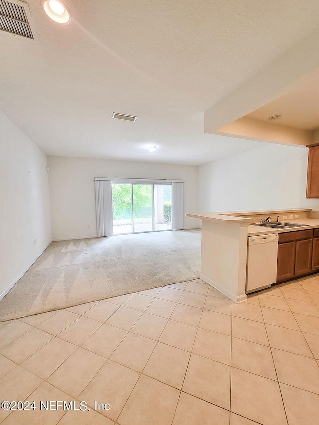 kitchen featuring sink, light colored carpet, and dishwasher