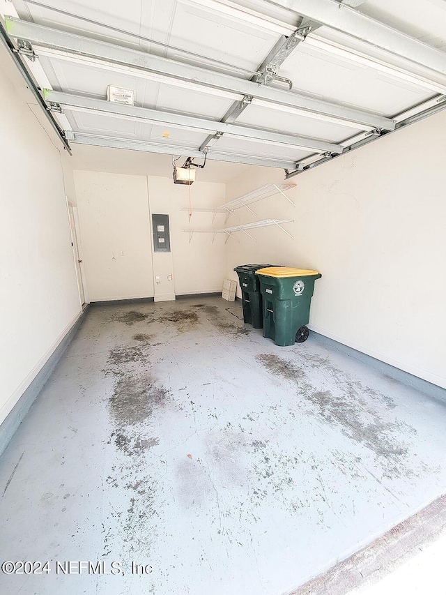 garage featuring a garage door opener and electric panel