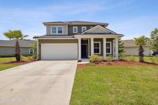 view of front of house with a garage and a front lawn