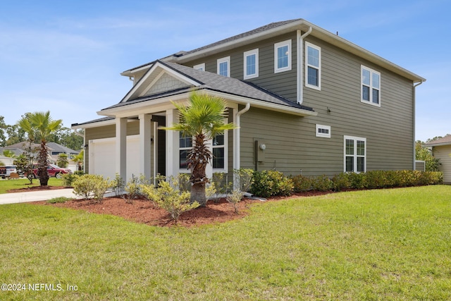 view of front facade featuring a garage and a front lawn