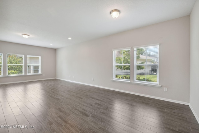 empty room with dark wood-type flooring