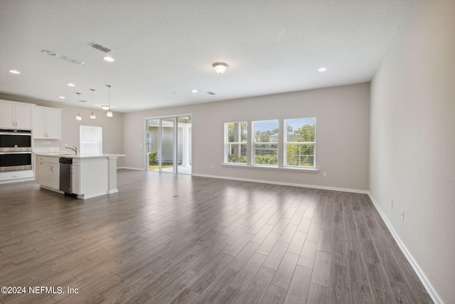 unfurnished living room with sink