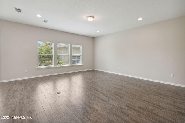 spare room featuring dark hardwood / wood-style flooring