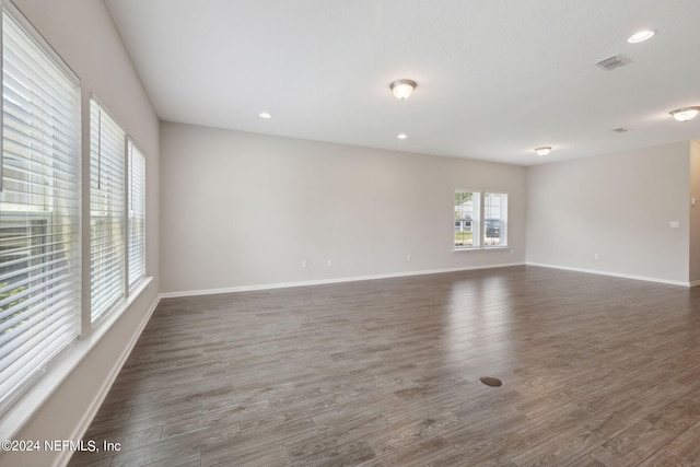 unfurnished room featuring dark wood-type flooring