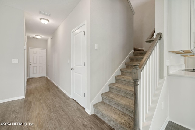 stairs with wood-type flooring