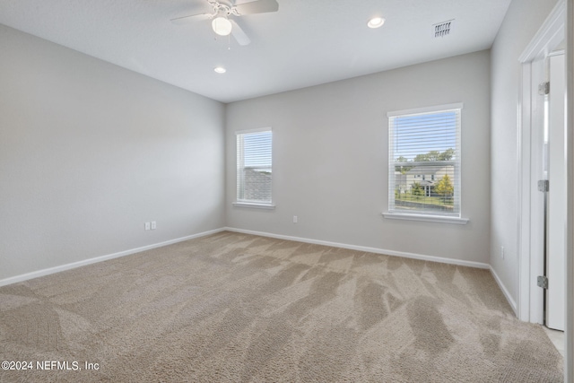 carpeted empty room featuring ceiling fan