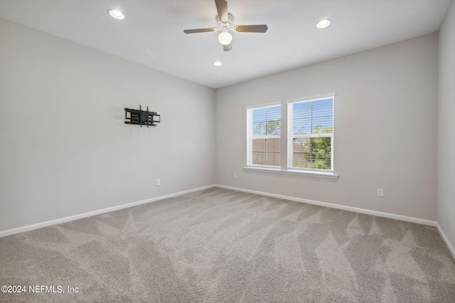 empty room with ceiling fan and carpet flooring