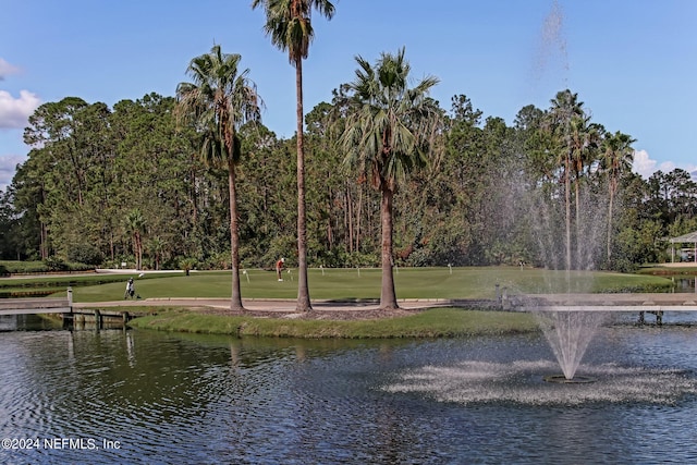 view of property's community featuring a yard and a water view