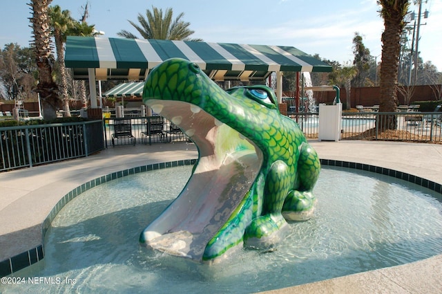 view of pool with a playground