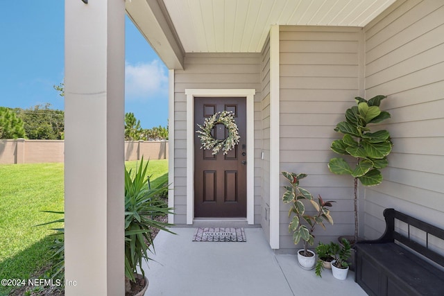 entrance to property with a lawn