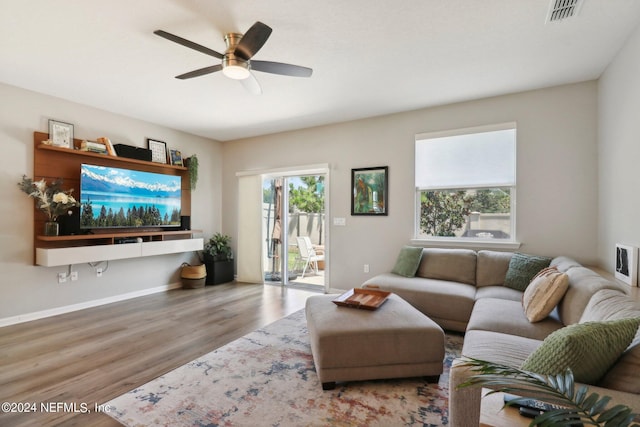 living room with wood-type flooring and ceiling fan