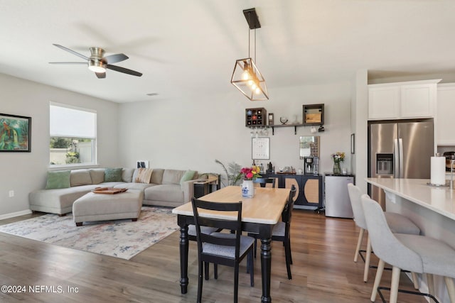 dining area featuring dark hardwood / wood-style floors and ceiling fan