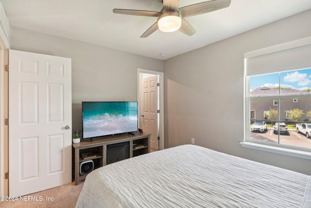 bedroom featuring light carpet and ceiling fan