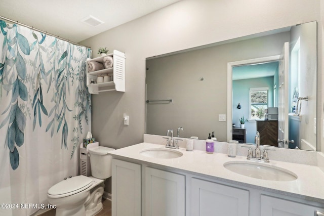 bathroom with vanity, a shower with curtain, and toilet