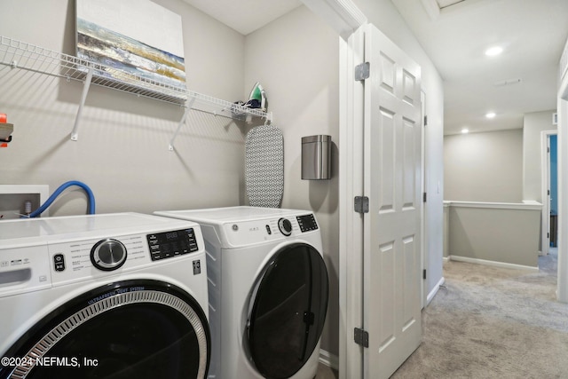 laundry area with light carpet and washer and dryer