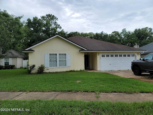 ranch-style house with a garage and a front lawn