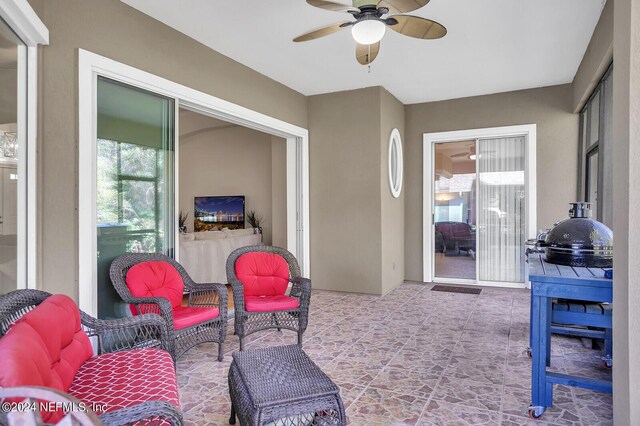 sunroom featuring ceiling fan