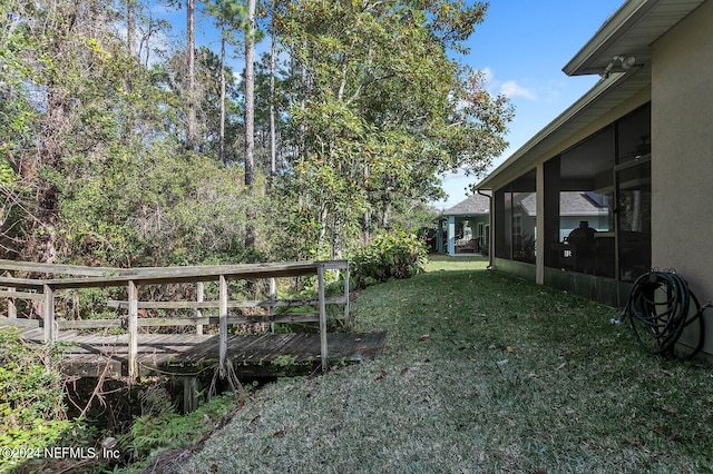 view of yard featuring a sunroom