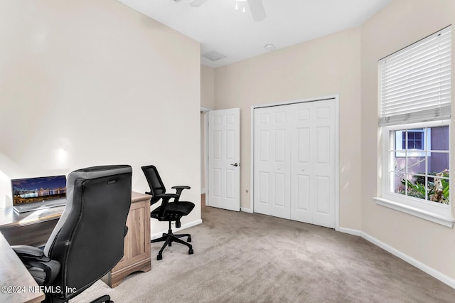 carpeted home office with ceiling fan