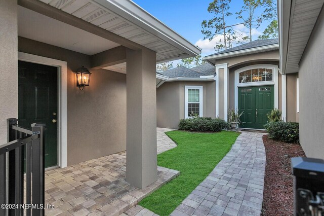 doorway to property with a yard