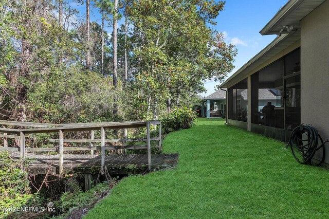 view of yard with a sunroom