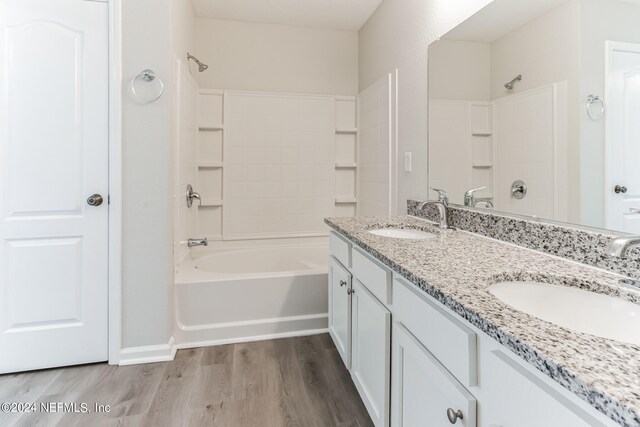 bathroom featuring vanity, bathtub / shower combination, and wood-type flooring