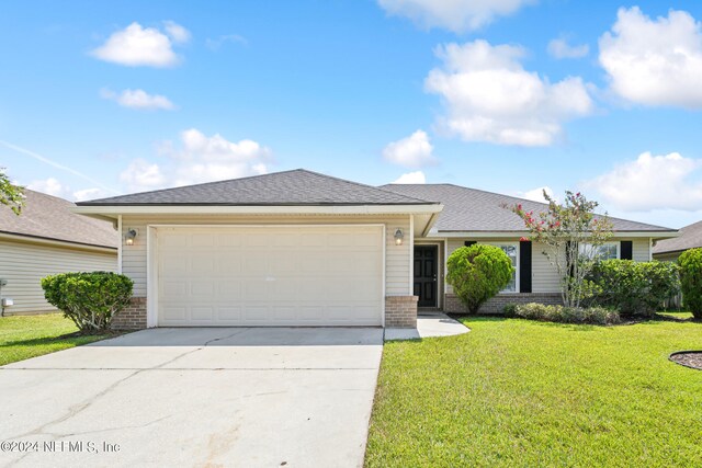 ranch-style house featuring a front yard and a garage