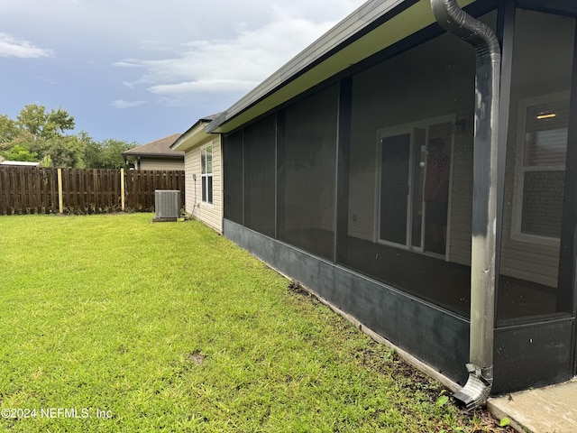 view of home's exterior featuring central AC unit and a lawn