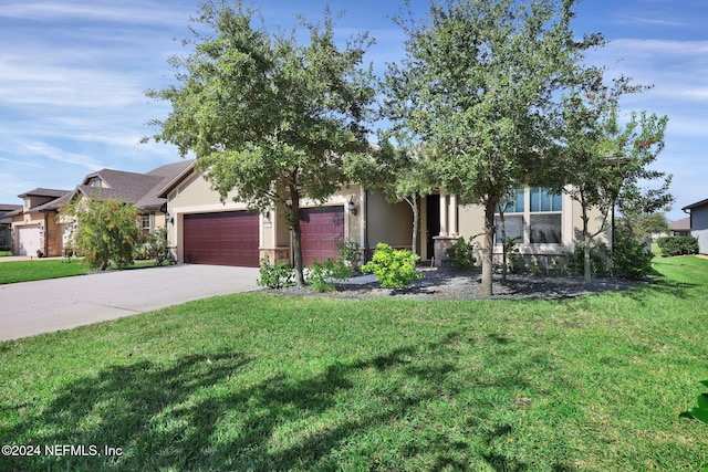 obstructed view of property featuring a garage and a front lawn