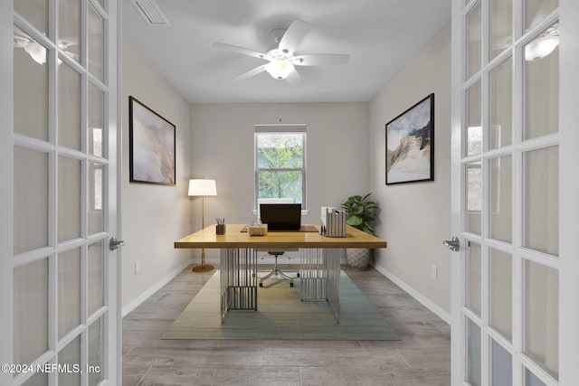 office space featuring french doors, hardwood / wood-style flooring, and ceiling fan