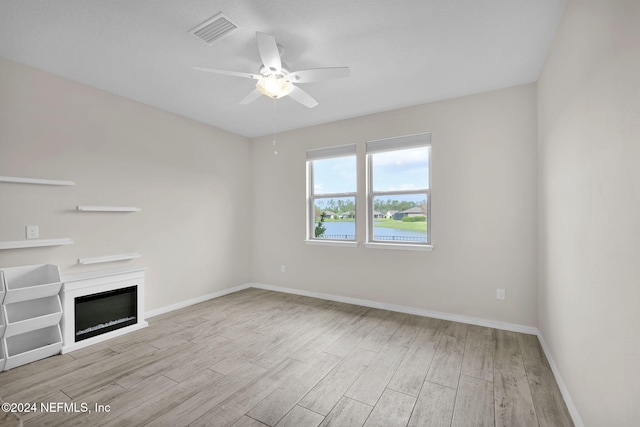 unfurnished living room featuring light hardwood / wood-style floors and ceiling fan