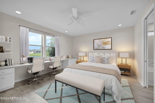 bedroom featuring ceiling fan, light hardwood / wood-style flooring, and built in desk