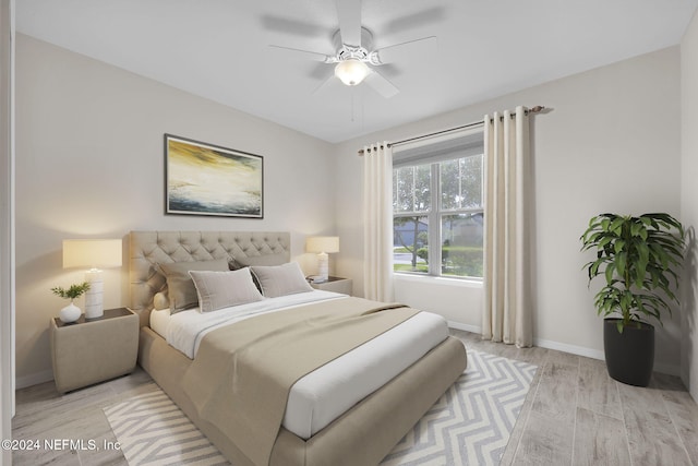 bedroom with light hardwood / wood-style floors and ceiling fan