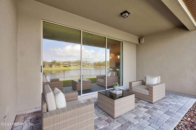 view of patio / terrace with a water view and an outdoor hangout area