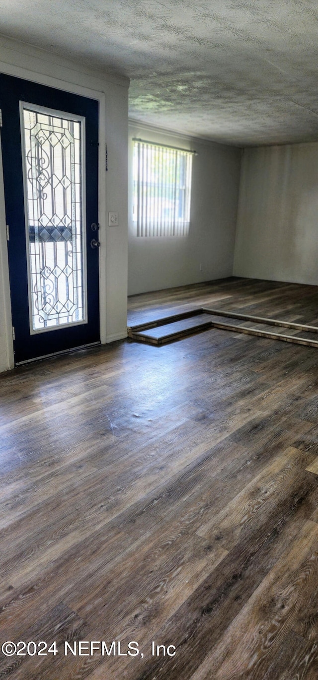 entryway featuring a textured ceiling and hardwood / wood-style flooring