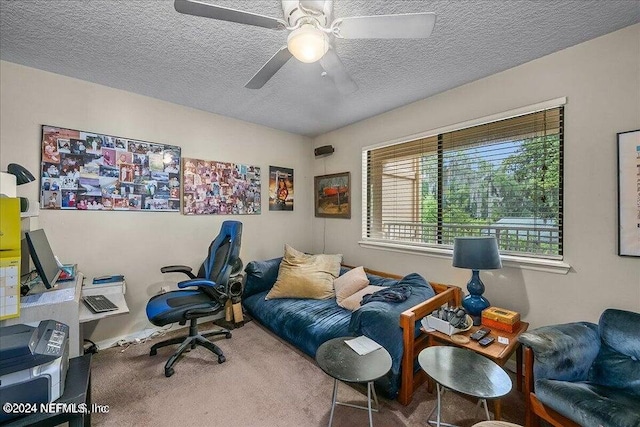 carpeted home office featuring ceiling fan and a textured ceiling