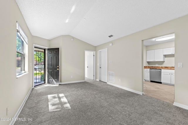 interior space with vaulted ceiling and a textured ceiling