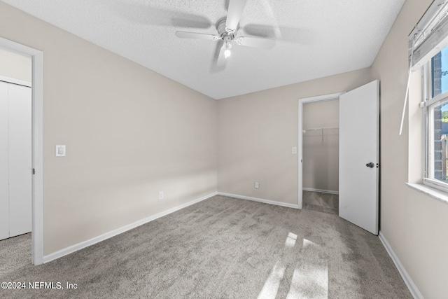 unfurnished bedroom with light carpet, ceiling fan, and a closet