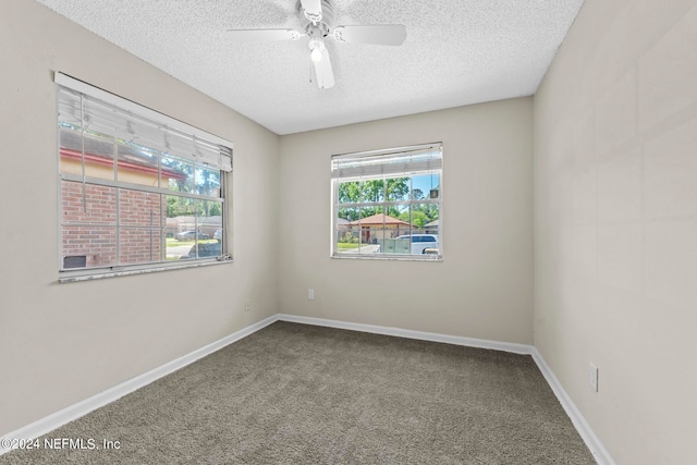 carpeted empty room with a textured ceiling and ceiling fan