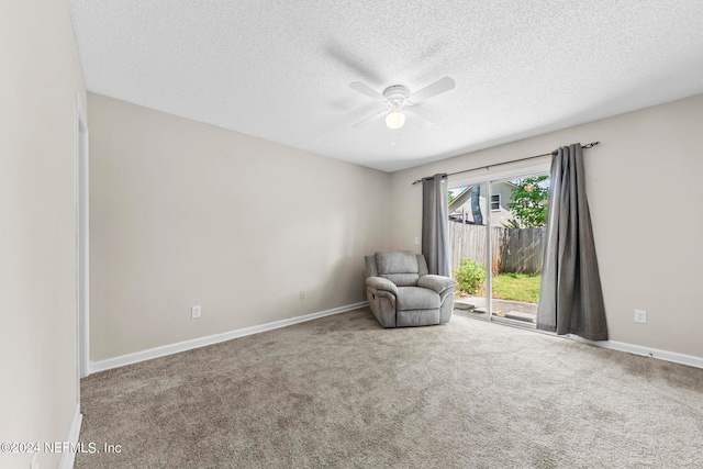 unfurnished room featuring carpet flooring, a textured ceiling, and ceiling fan