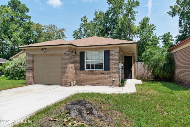 single story home with a garage and a front lawn