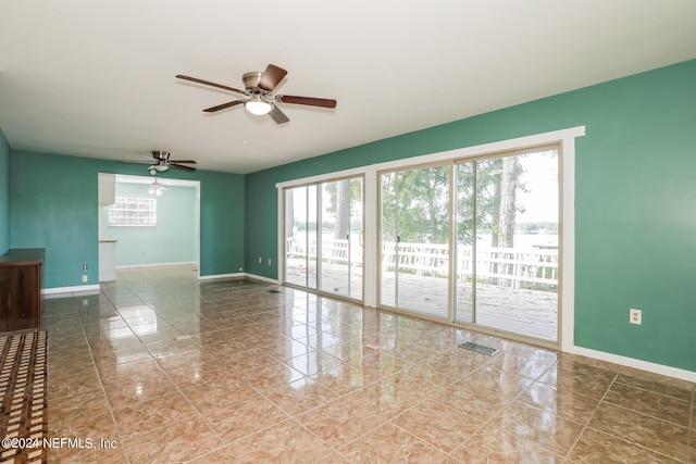 spare room featuring ceiling fan and tile patterned floors