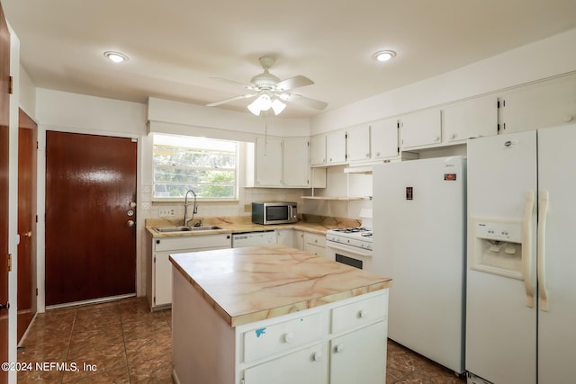 kitchen with white appliances, ceiling fan, dark tile patterned flooring, decorative backsplash, and sink