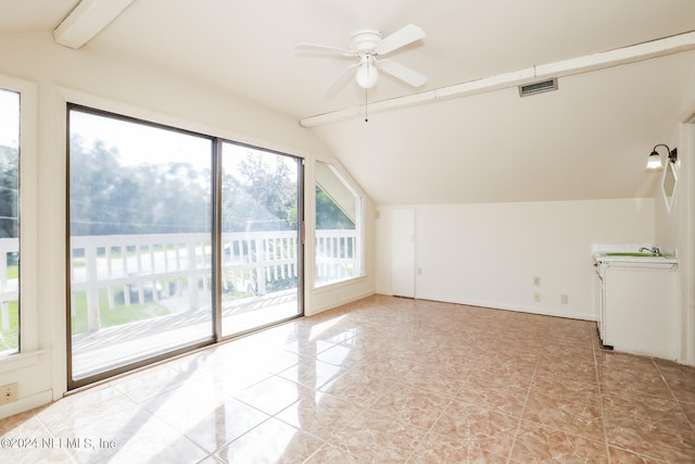 additional living space with light tile patterned flooring, sink, ceiling fan, and lofted ceiling