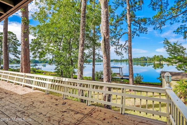 view of patio / terrace with a dock and a water view