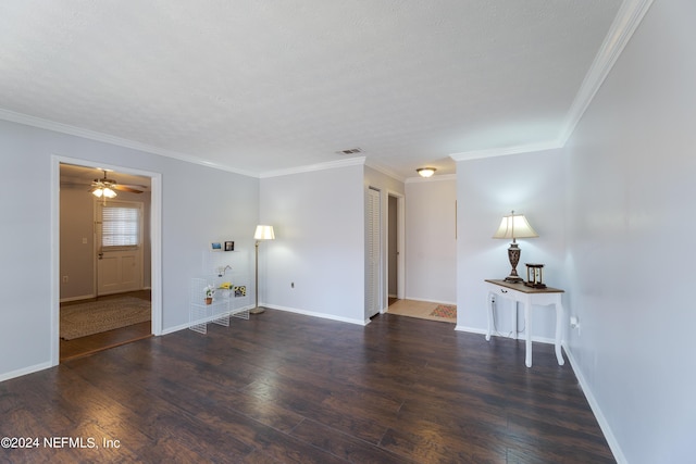 spare room featuring ornamental molding, dark hardwood / wood-style floors, and a textured ceiling